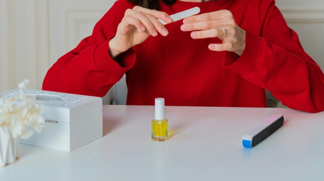 κοπέλα που λιμάρει τα νύχια της 