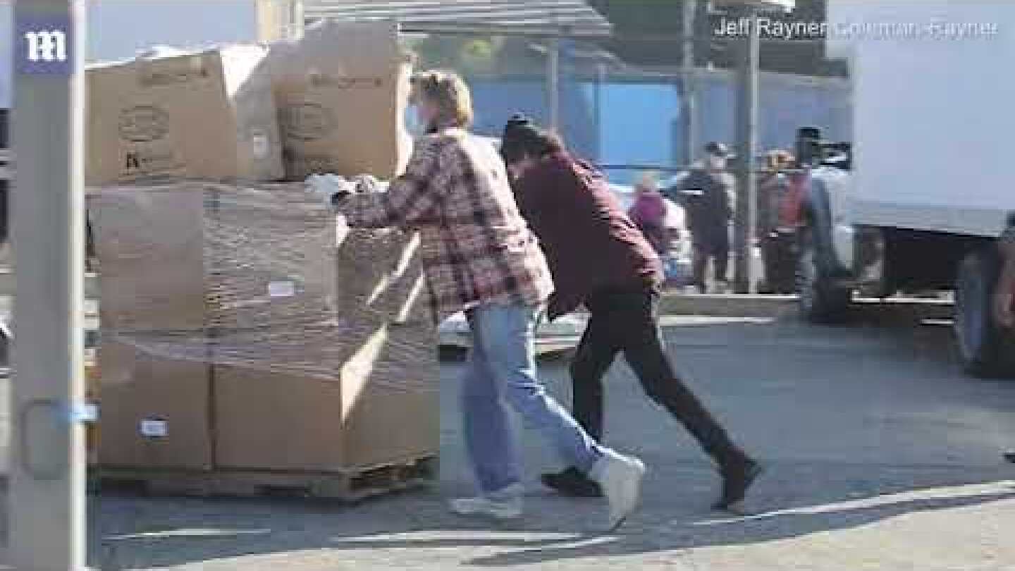 Brad Pitt unloading and handing out boxes of groceries to low-income families in South Central LA