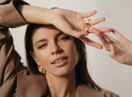 Μελαχρινή κοπέλα κοιτάει την κάμερα και χαμογελάει