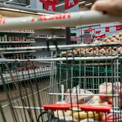 Καρότσι με τρόφιμα σε διάδρομο σούπερ μάρκετ
