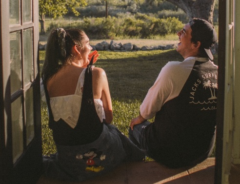 Άντρας και γυναίκα καθιστοί γελάνε