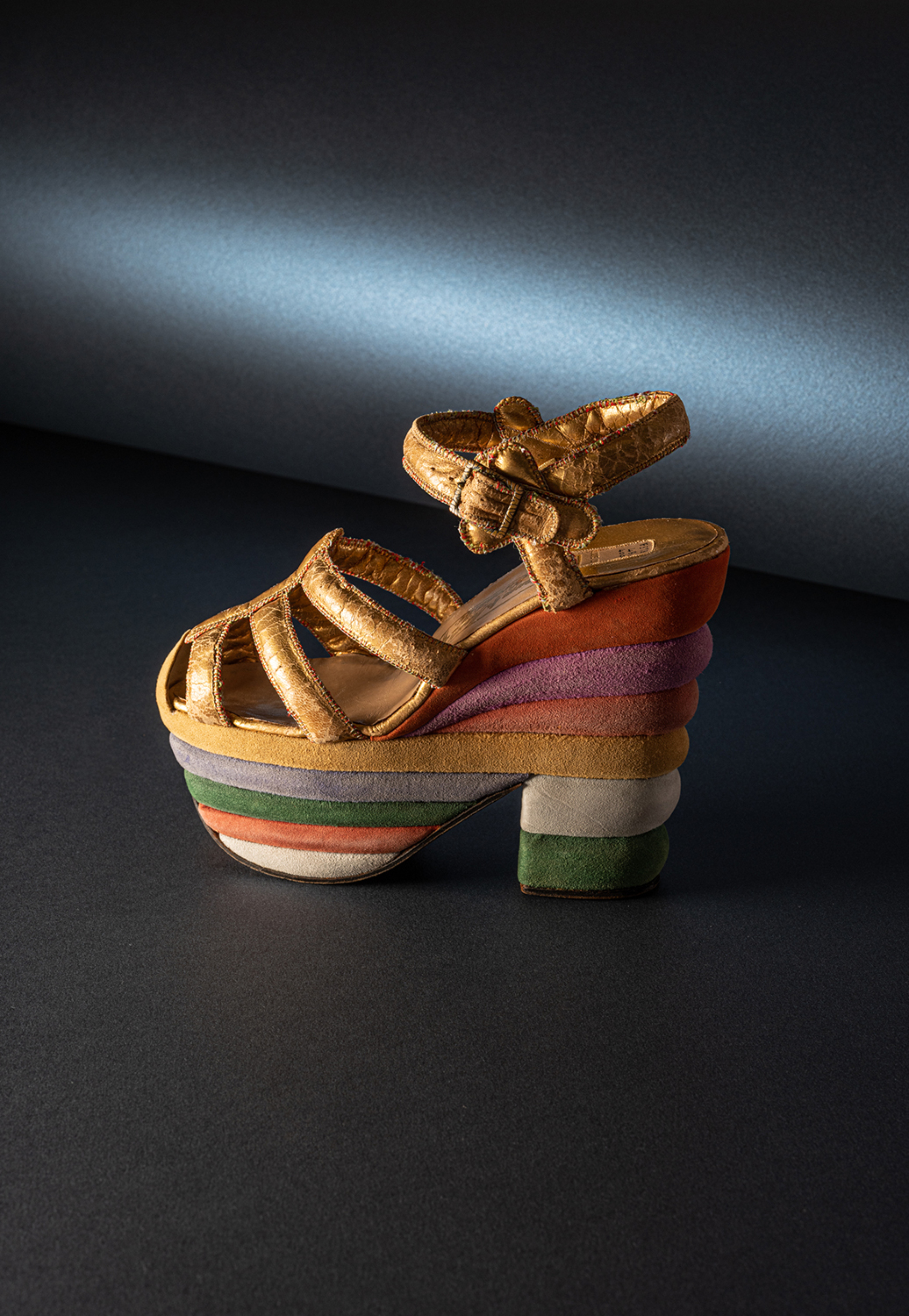 Salvatore Ferragamo, «Rainbow», δέρμα και σουέτ με πολυεπίπεδο τακούνι και πλατφόρμα σε καλυμμένο φελλό, 1938. Μοντέλο που δημιουργήθηκε για την ηθοποιό Judy Garland