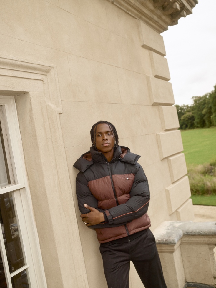 ellesse_aw24q3_mens_mainrange_campaign_shx21097_appiani2_paddedjacket_brownblack_shx21101_tricaso_trackpant_black_image_2